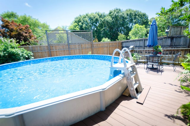 view of swimming pool with a deck