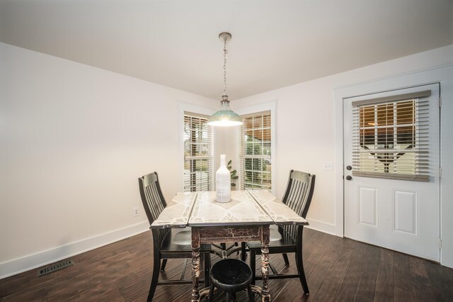 dining room with dark hardwood / wood-style flooring