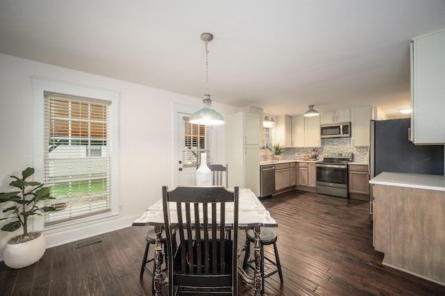 dining area featuring dark hardwood / wood-style flooring