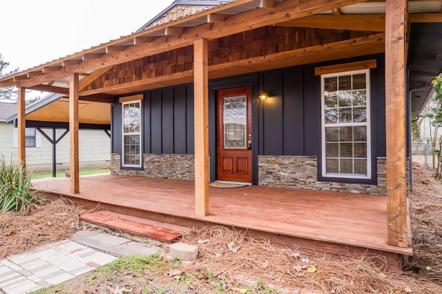 view of exterior entry featuring covered porch