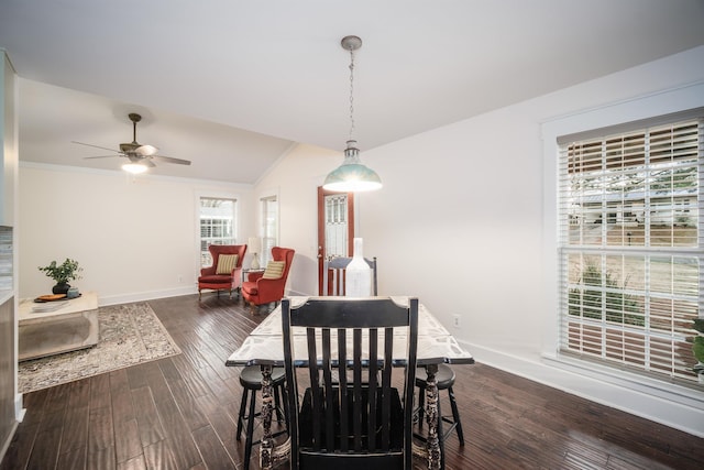 dining space featuring ceiling fan, dark hardwood / wood-style flooring, crown molding, and vaulted ceiling