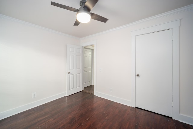 unfurnished bedroom with dark hardwood / wood-style flooring, a closet, ceiling fan, and ornamental molding