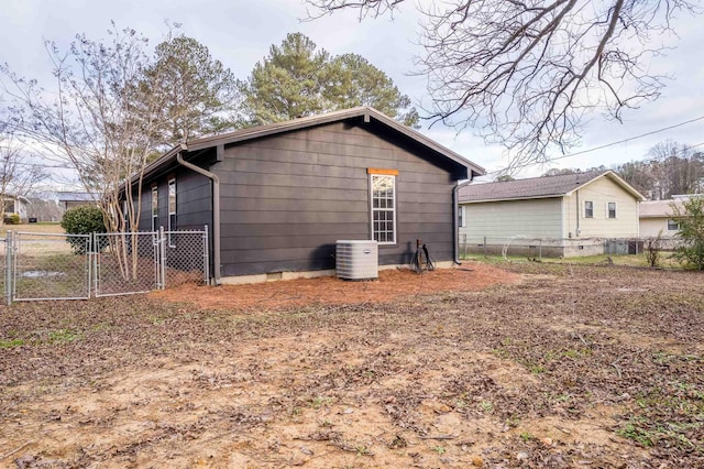 rear view of property featuring central AC