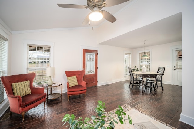 living room with ceiling fan, dark wood-type flooring, a wealth of natural light, and vaulted ceiling