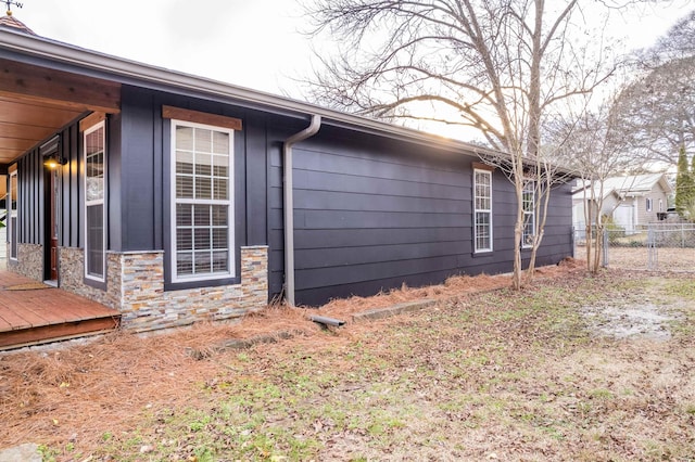 view of side of property featuring a wooden deck