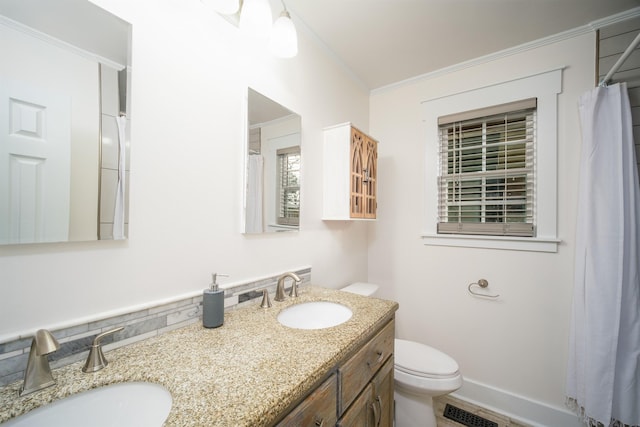 bathroom featuring crown molding, vanity, and toilet