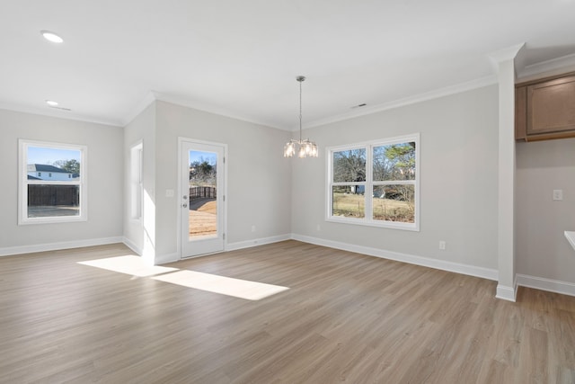 unfurnished dining area featuring baseboards, light wood-type flooring, a notable chandelier, and a healthy amount of sunlight