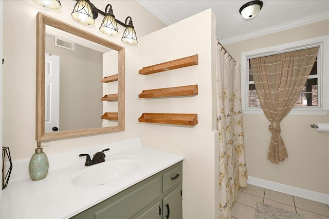 bathroom featuring a textured ceiling, vanity, visible vents, ornamental molding, and tile patterned floors