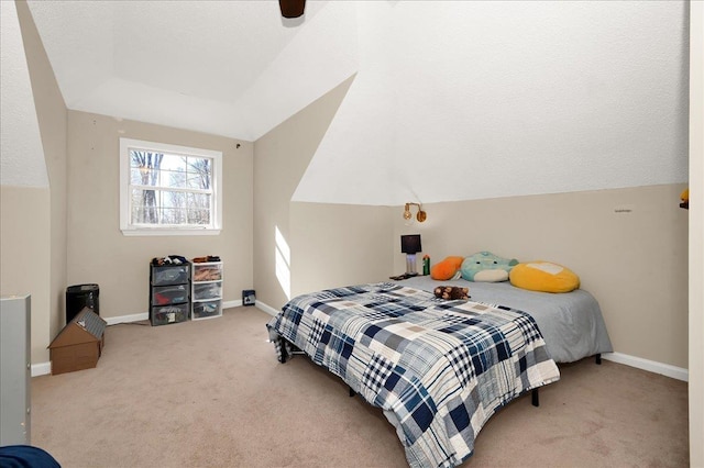 bedroom with baseboards, lofted ceiling, and light colored carpet