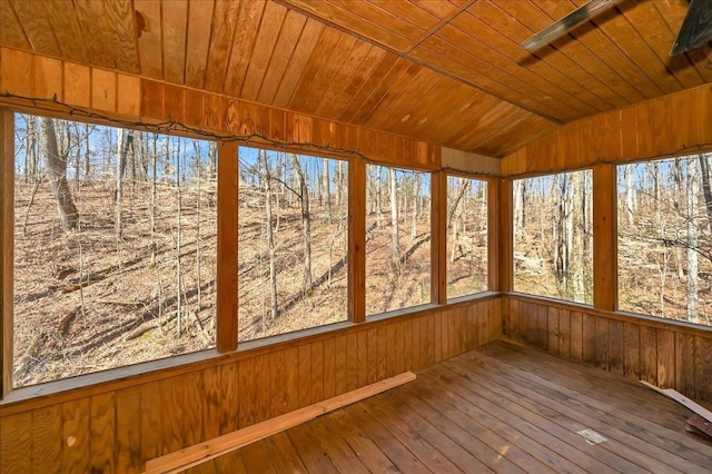 unfurnished sunroom with vaulted ceiling and wooden ceiling