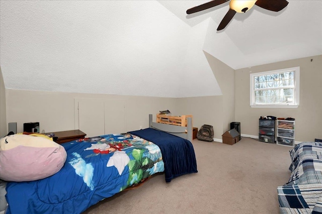 bedroom featuring baseboards, a ceiling fan, lofted ceiling, carpet, and a textured ceiling