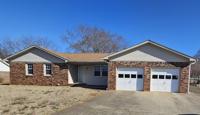 ranch-style house featuring a garage, brick siding, crawl space, and aphalt driveway