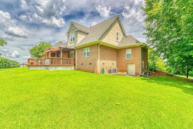 - back of property featuring a deck, a lawn, brick siding, and roof with shingles