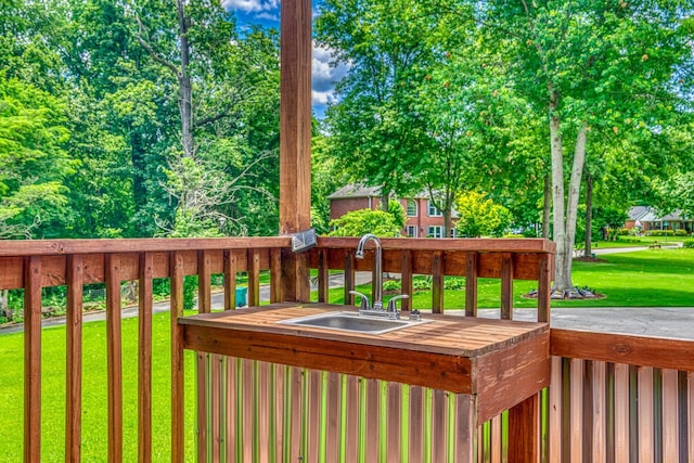  - wooden deck with a sink and a lawn