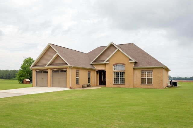  - view of front of home with central AC unit, driveway, roof with shingles, a front yard, and an attached garage
