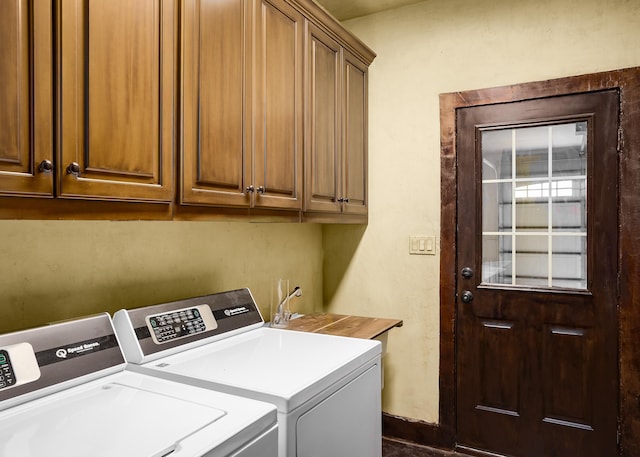  - laundry area featuring separate washer and dryer, cabinet space, and baseboards
