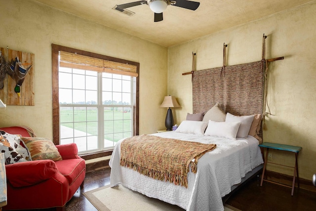  - bedroom featuring multiple windows, ceiling fan, and visible vents