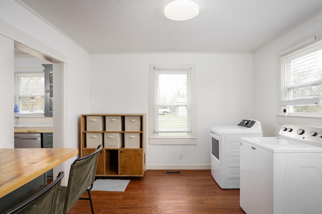 laundry area featuring ornamental molding, laundry area, independent washer and dryer, and dark wood-style flooring