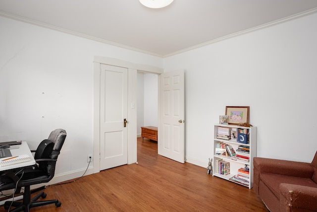 office area with crown molding, baseboards, and wood finished floors