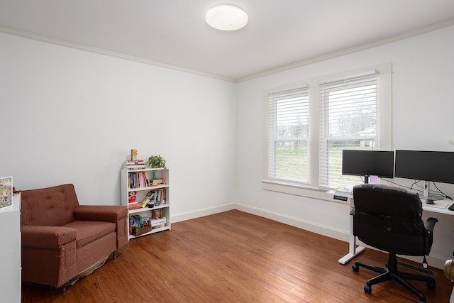 office space with ornamental molding, baseboards, and wood finished floors