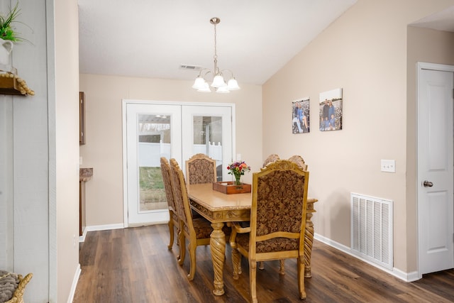 dining room featuring vaulted ceiling, dark hardwood / wood-style flooring, and a chandelier