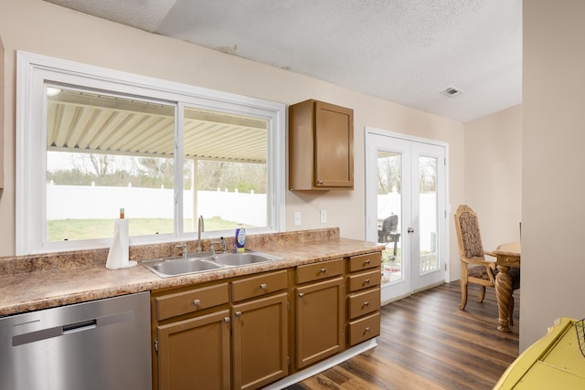 kitchen featuring french doors, a textured ceiling, sink, dishwasher, and dark hardwood / wood-style floors