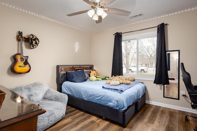 bedroom with ceiling fan and dark hardwood / wood-style flooring