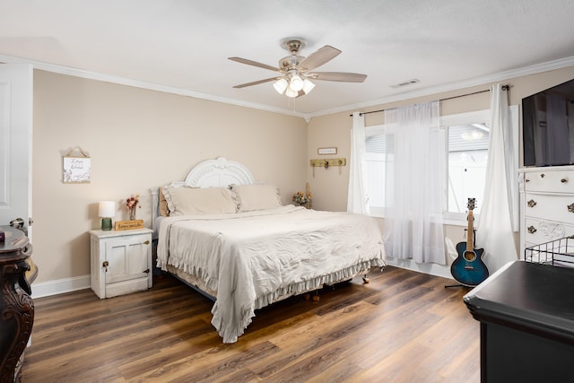 bedroom featuring dark hardwood / wood-style floors, ceiling fan, and crown molding