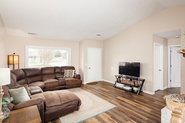 living room featuring dark hardwood / wood-style flooring and vaulted ceiling