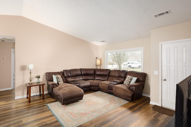 living room featuring dark hardwood / wood-style floors and lofted ceiling