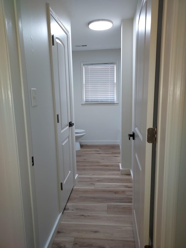 hall with light hardwood / wood-style flooring