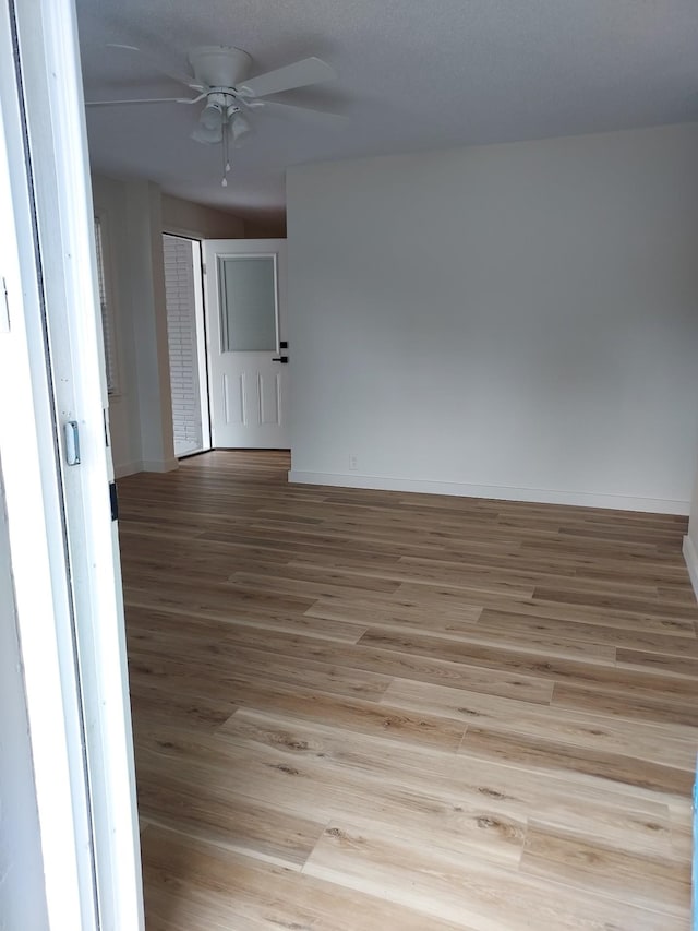 spare room with light hardwood / wood-style flooring and ceiling fan