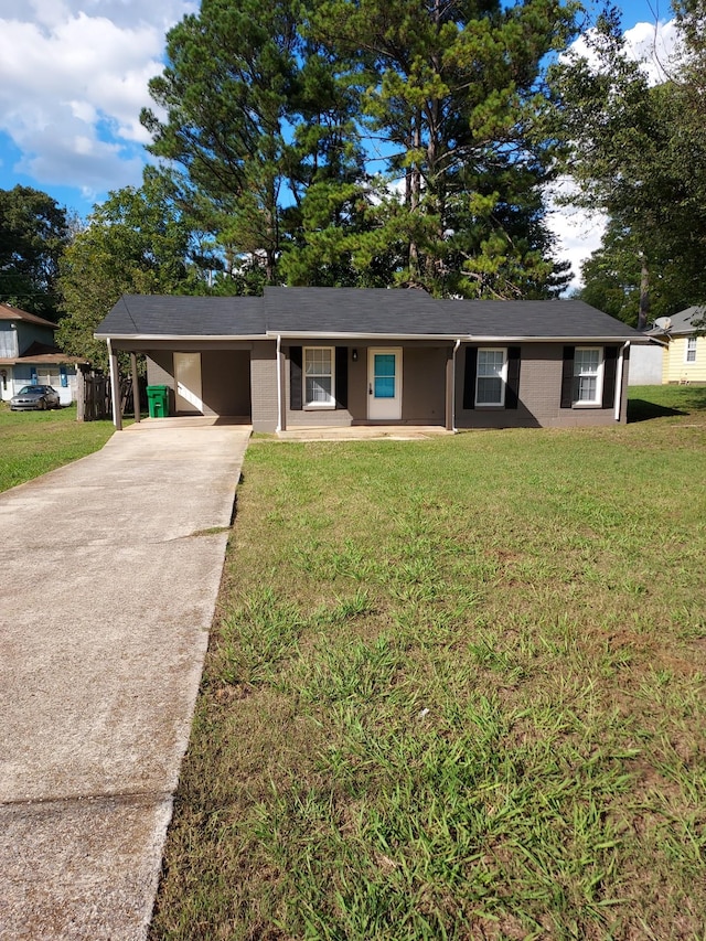 ranch-style home featuring covered porch, a front yard, and a carport