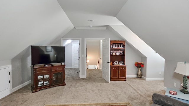 interior space featuring carpet floors, baseboards, and lofted ceiling