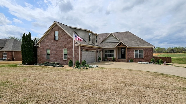 view of front of house with a front lawn, roof with shingles, brick siding, and concrete driveway