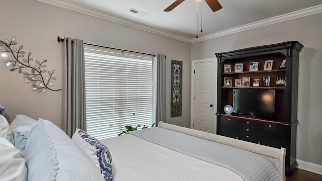 bedroom with baseboards, visible vents, crown molding, and a ceiling fan