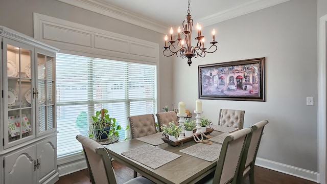 dining room with dark wood-style floors, baseboards, ornamental molding, and a chandelier