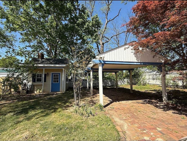  - view of yard featuring a carport and an outbuilding