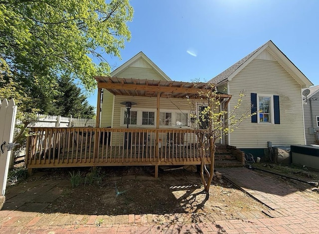  - back of property featuring a deck and a pergola