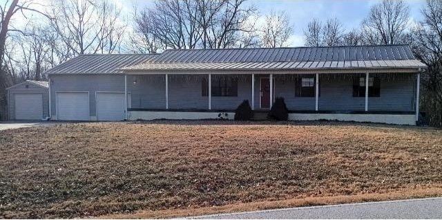 ranch-style house with a porch and a garage