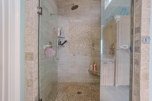 bathroom with a shower with door