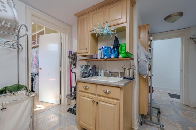 kitchen featuring light brown cabinets and sink