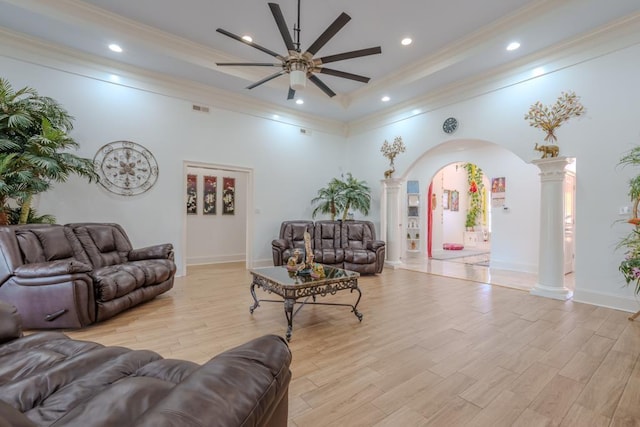 living room featuring light hardwood / wood-style flooring, ornate columns, ceiling fan, and ornamental molding