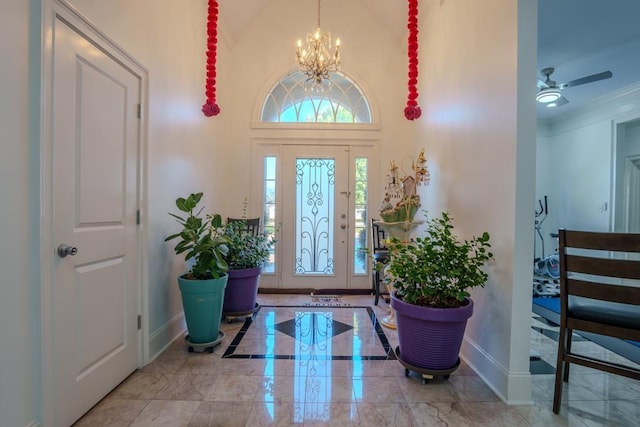 entrance foyer featuring ceiling fan with notable chandelier