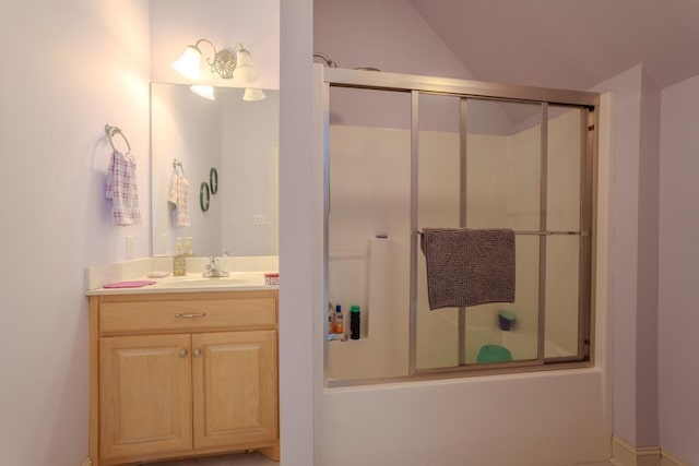 bathroom featuring vanity and shower / bath combination with glass door