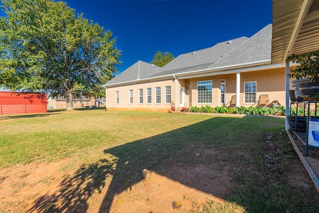 rear view of house featuring a yard