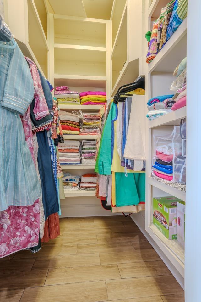 spacious closet with light hardwood / wood-style floors