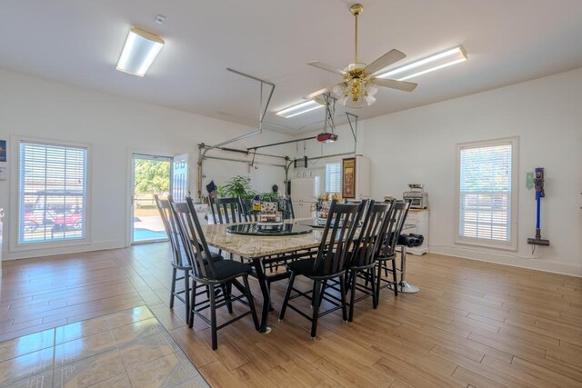 dining space with a wealth of natural light, light hardwood / wood-style flooring, and ceiling fan