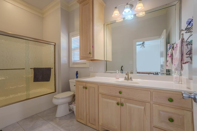 full bathroom featuring tile patterned floors, ceiling fan, toilet, enclosed tub / shower combo, and ornamental molding