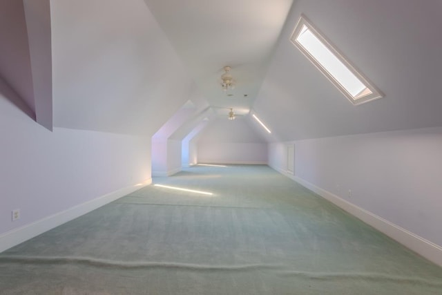 bonus room with carpet and lofted ceiling with skylight